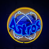 Round neon sign with a yellow outer ring, white atomic orbit graphic, and bright blue text spelling Houston Astros