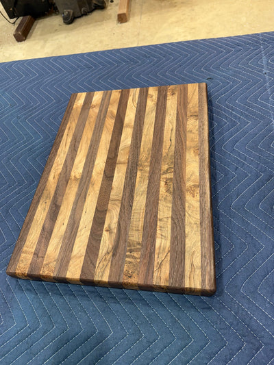 Maple and walnut cutting board with natural wood grain