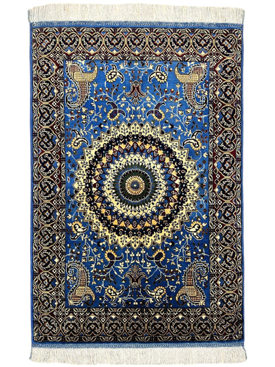 Hand-knotted Parak rug in sky blue with geometric patterns displayed on a wooden floor