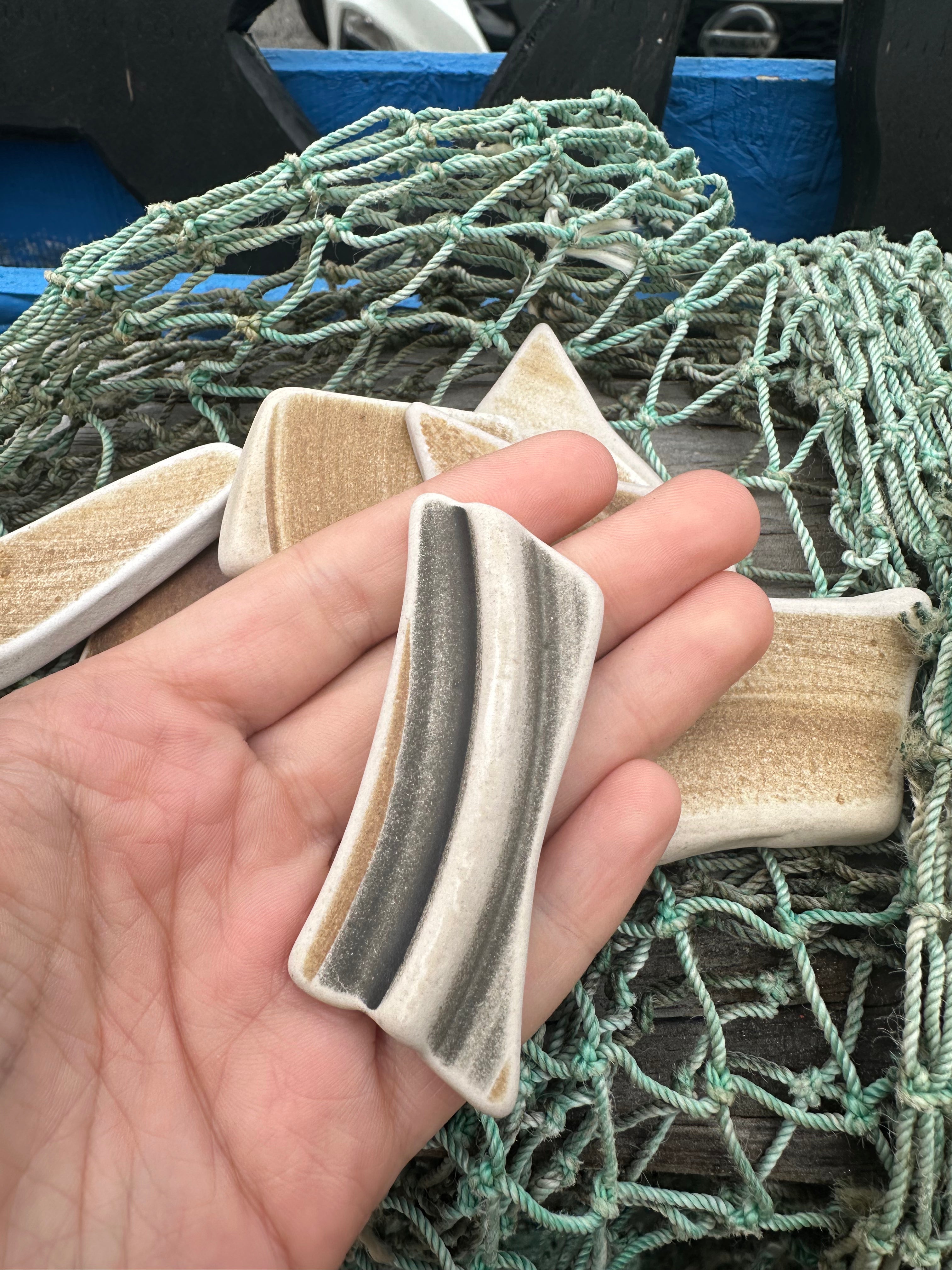 Assorted hand-tumbled pottery pieces in earthy colors for mosaic crafts