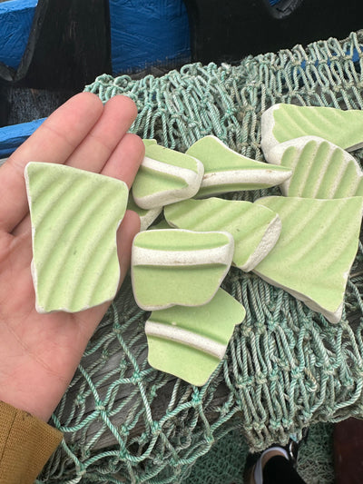 Assorted hand-tumbled pottery pieces in earthy colors for mosaic crafts