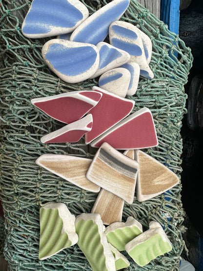 Assorted hand-tumbled pottery pieces in earthy colors for mosaic crafts