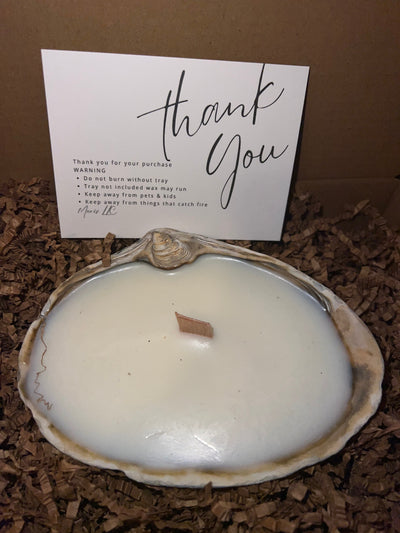 Limited edition candle in a dark, weathered quahog shell from December 2025 storm