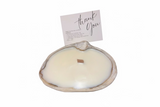 Limited edition candle in a dark, weathered quahog shell from December 2025 storm