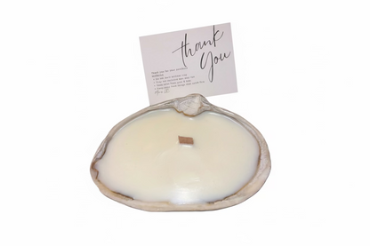 Limited edition candle in a dark, weathered quahog shell from December 2025 storm