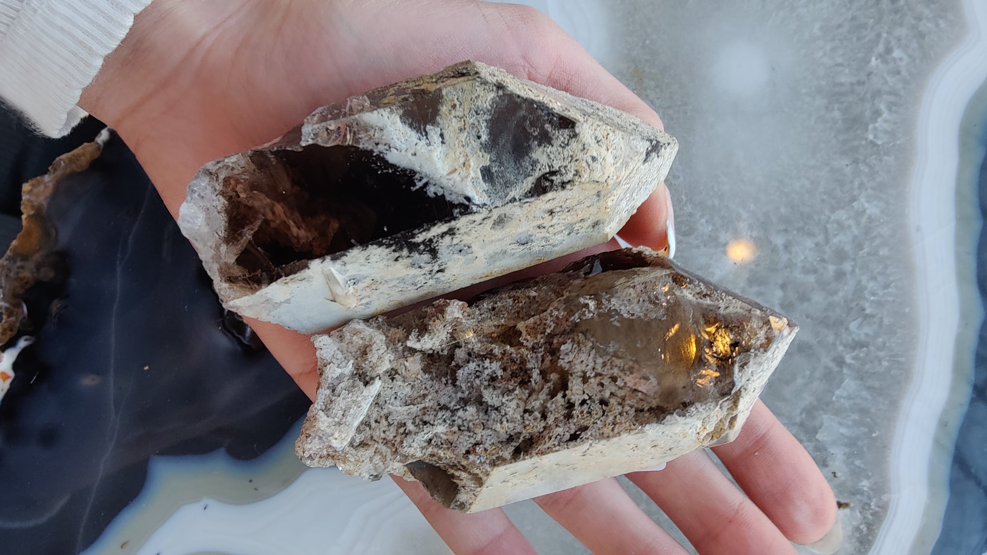 Lodalite Included Smokey Quartz Point mineral specimen resting on a neutral white surface