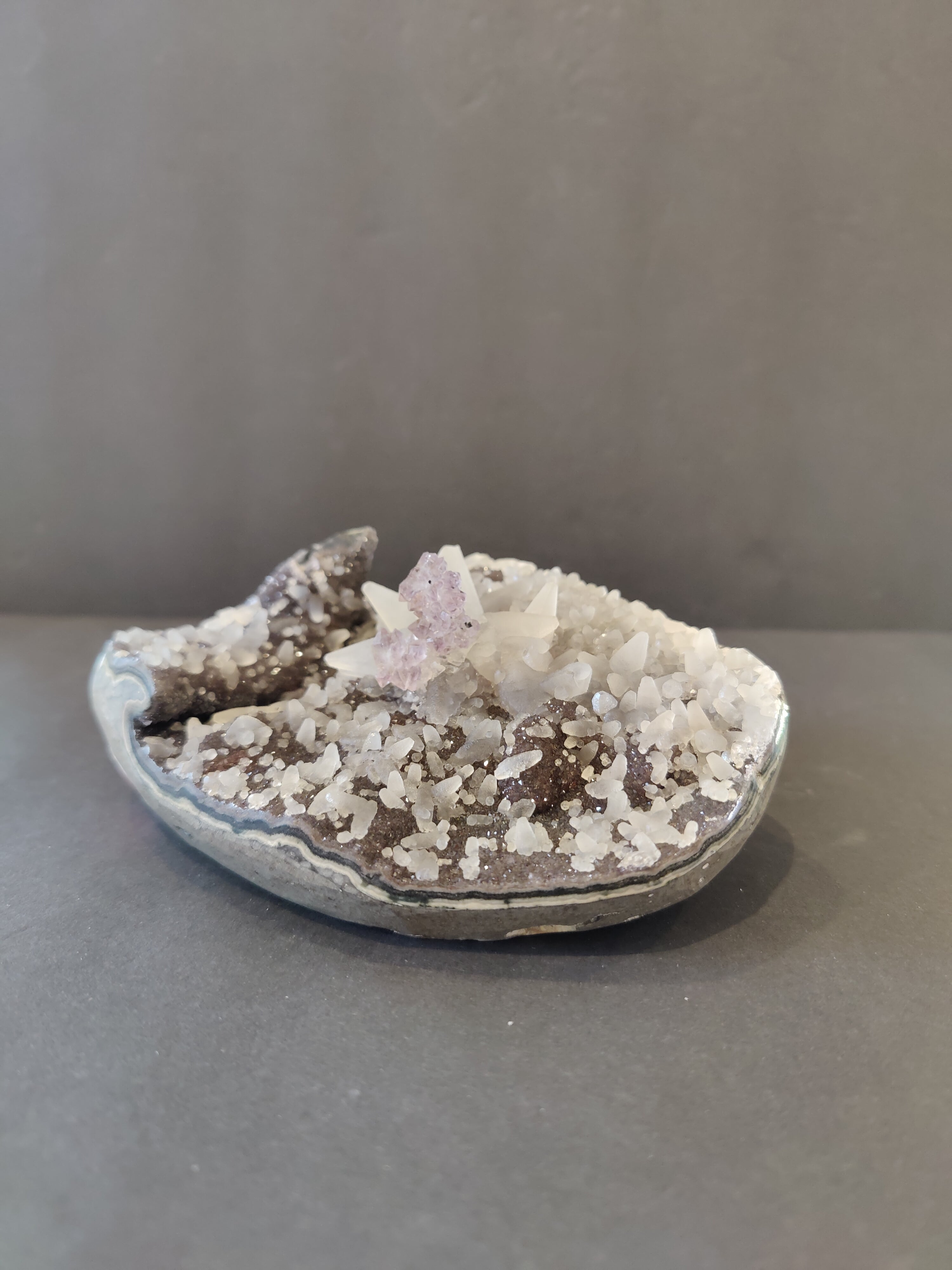 Polished Amethyst geode sculpture with dogtooth calcite inclusions