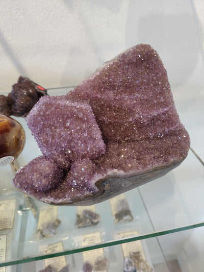 Amethyst Geode Sculpture with polished edges, showcasing deep purple crystals and rough outer surface