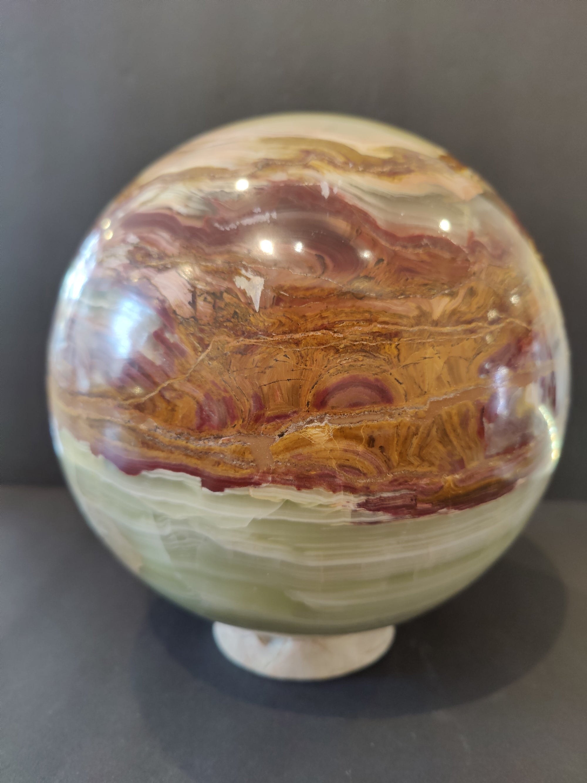 Green Onyx sphere 8 inches diameter displayed on a matching Onyx stand