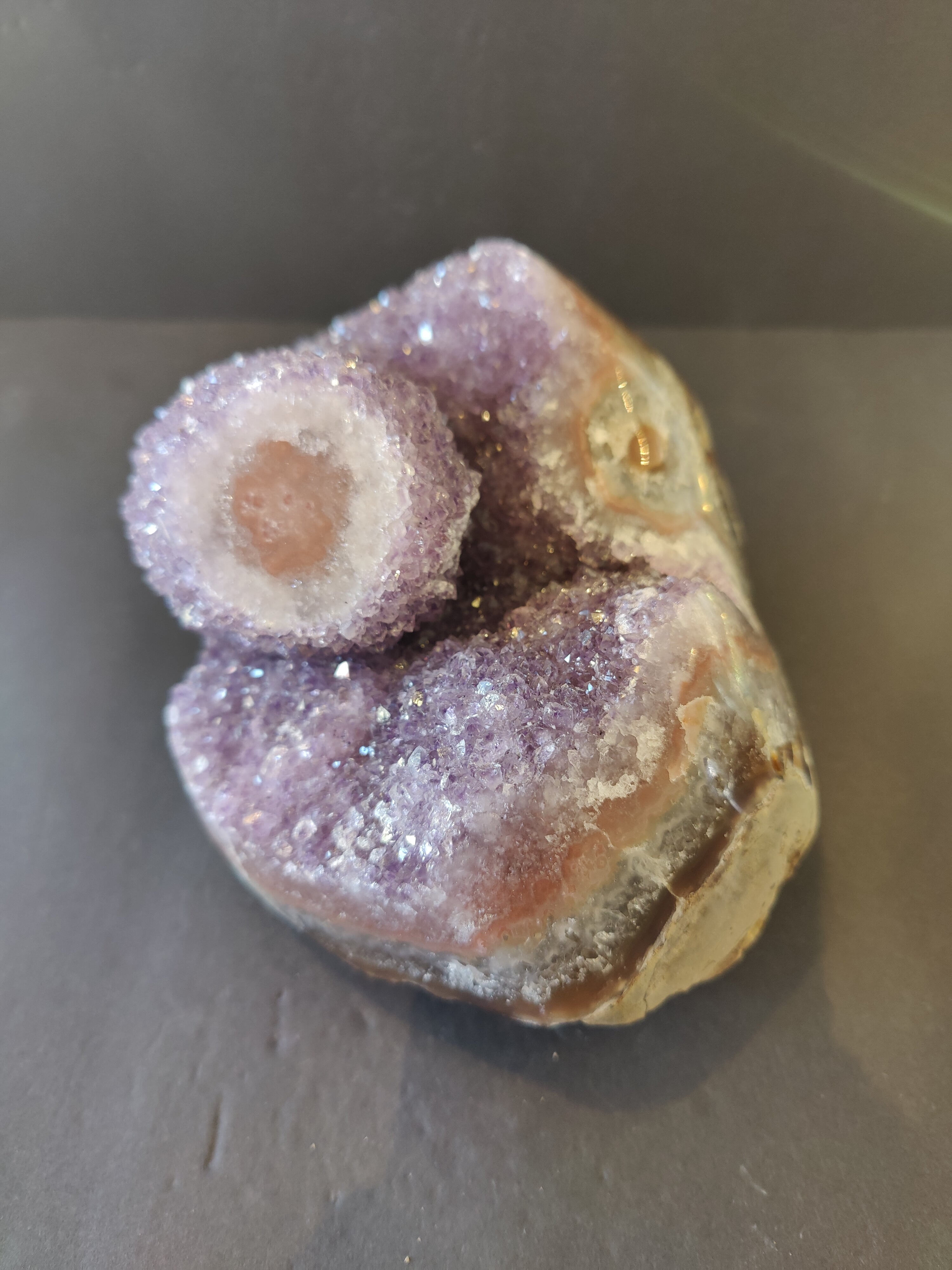 Amethyst Geode with polished edge and stalactite formation, purple crystals visible inside