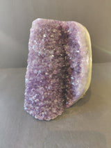 Amethyst Cut Base Geode with polished edge banded agate on a white background
