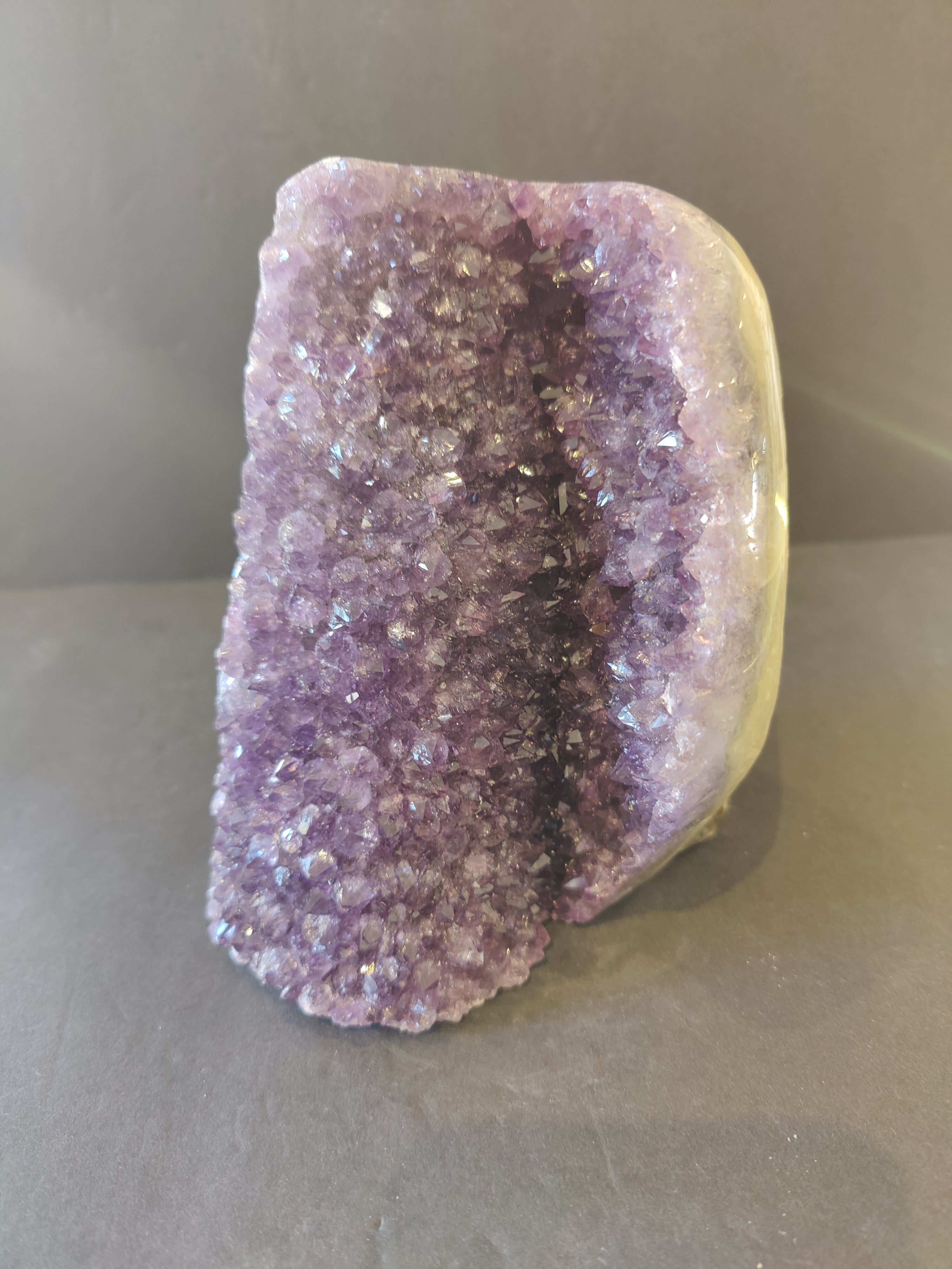 Amethyst Cut Base Geode with polished edge banded agate on a white background
