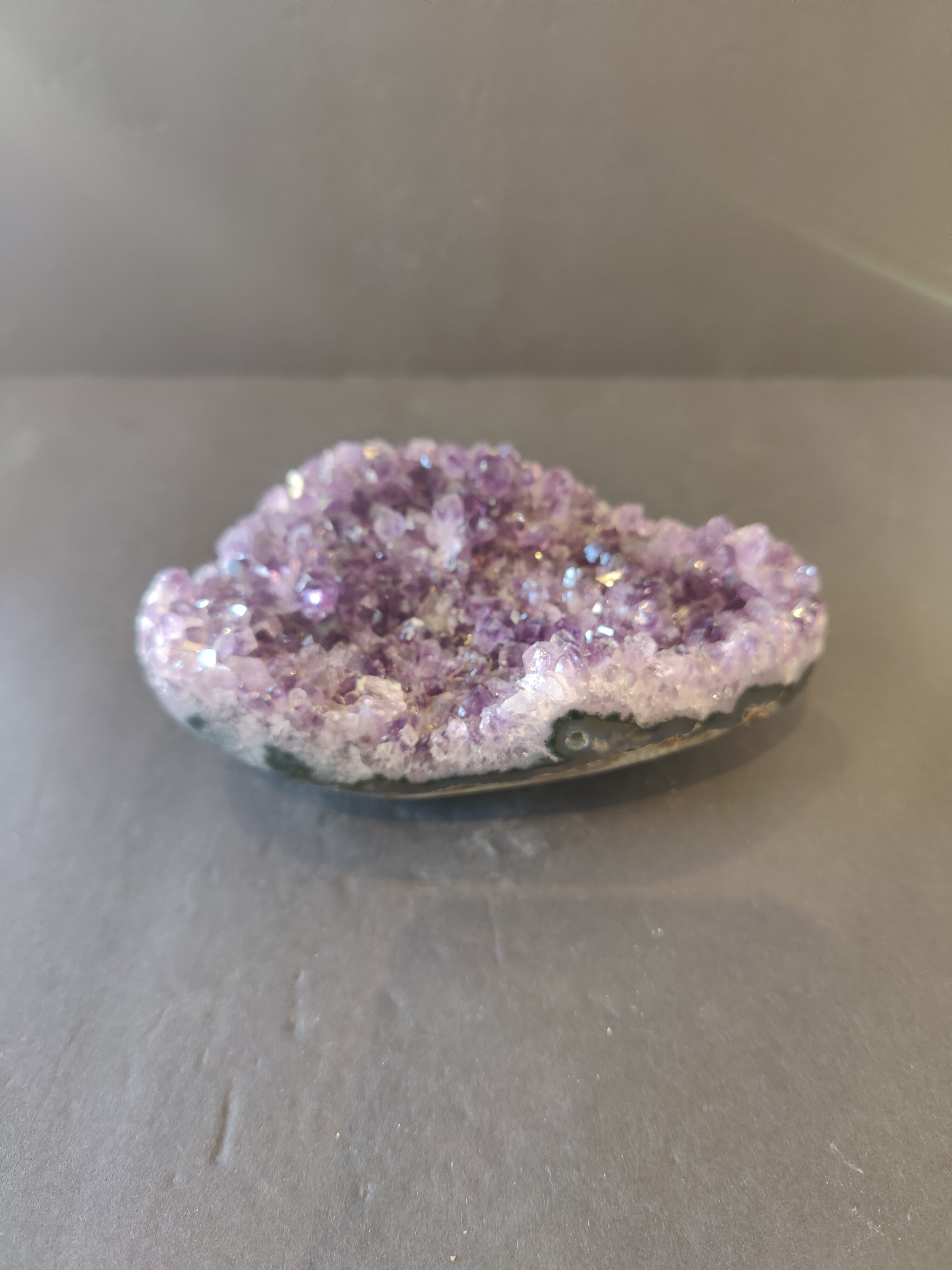 Amethyst cut base geode with purple crystals and polished agate edge