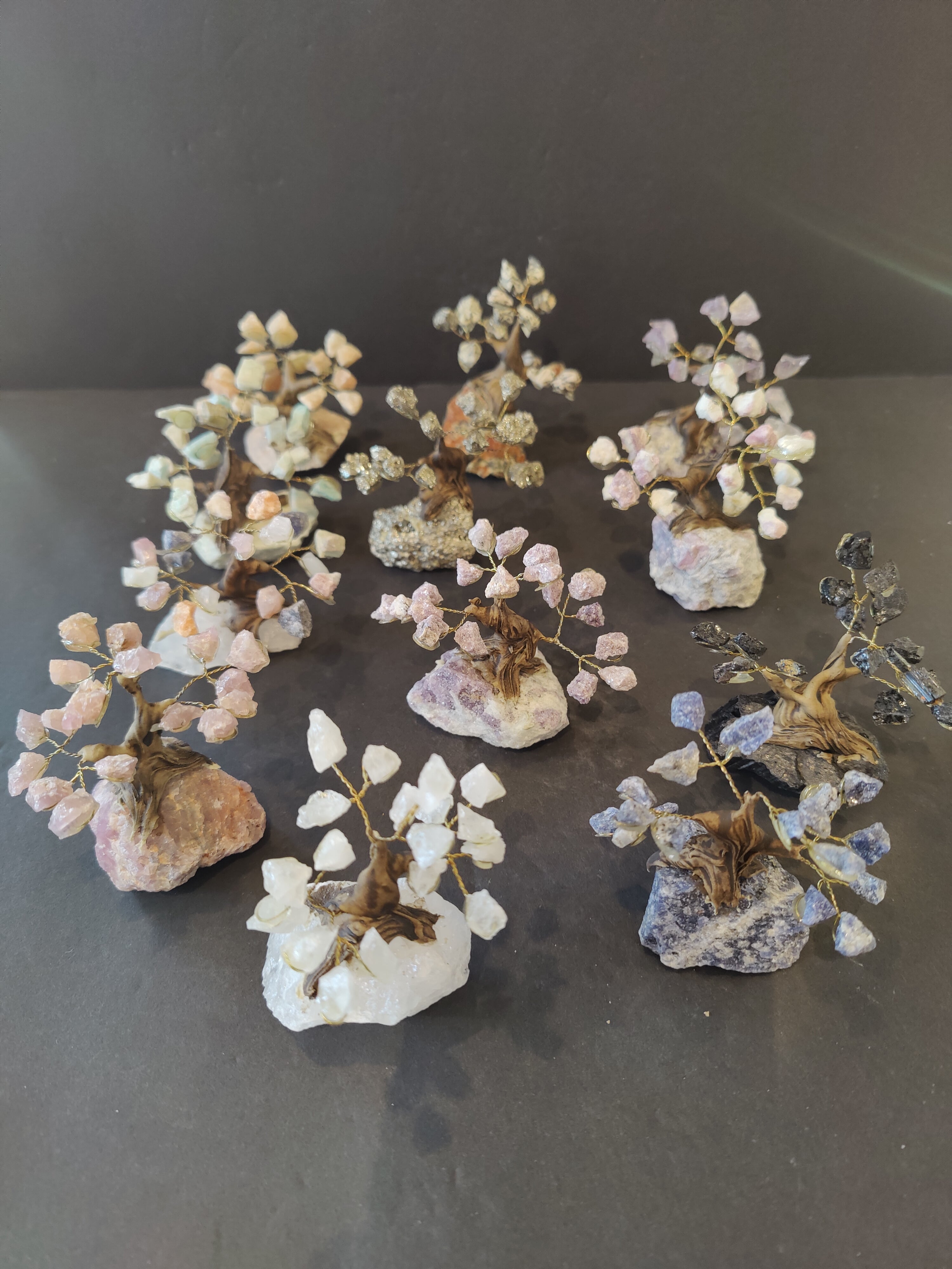 Small 3-inch bonsai tree sculpture made of assorted polished stones, displayed against a white background.
