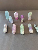Multi Color Fluorite Points showing layered mineral patterns in Cut Base Tower and Round Base Massage Wand shapes