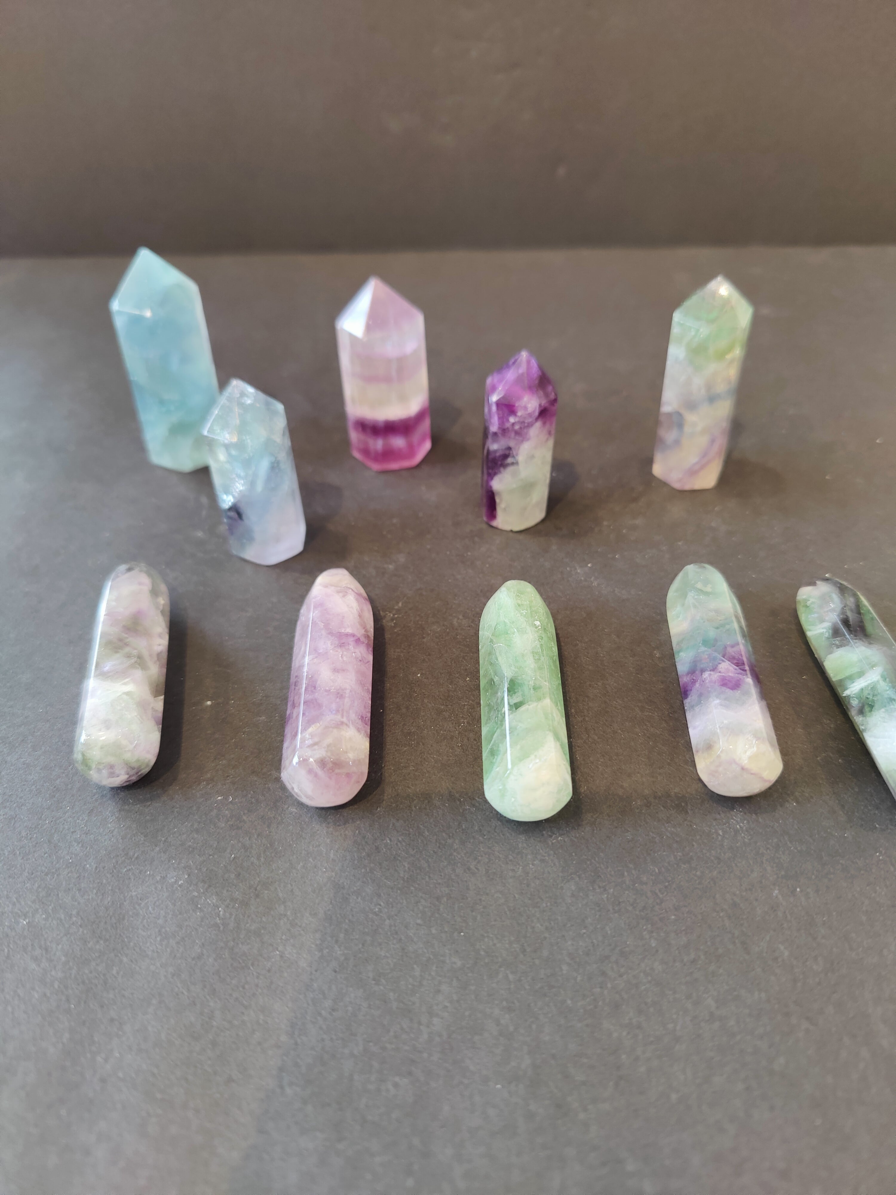 Multi Color Fluorite Points showing layered mineral patterns in Cut Base Tower and Round Base Massage Wand shapes