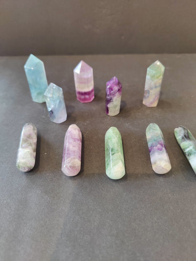 Multi Color Fluorite Points showing layered mineral patterns in Cut Base Tower and Round Base Massage Wand shapes
