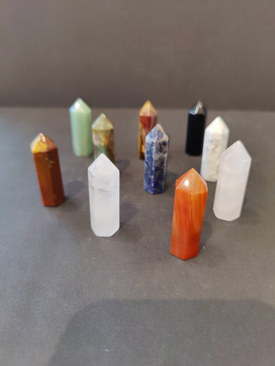 Crystal Cut Base Tower Sculpture featuring varied natural stone bases with faceted surfaces