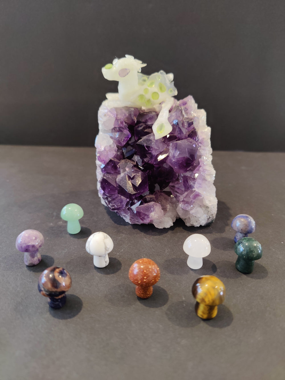 Pocket sized mushroom stone sculpture on a plain surface