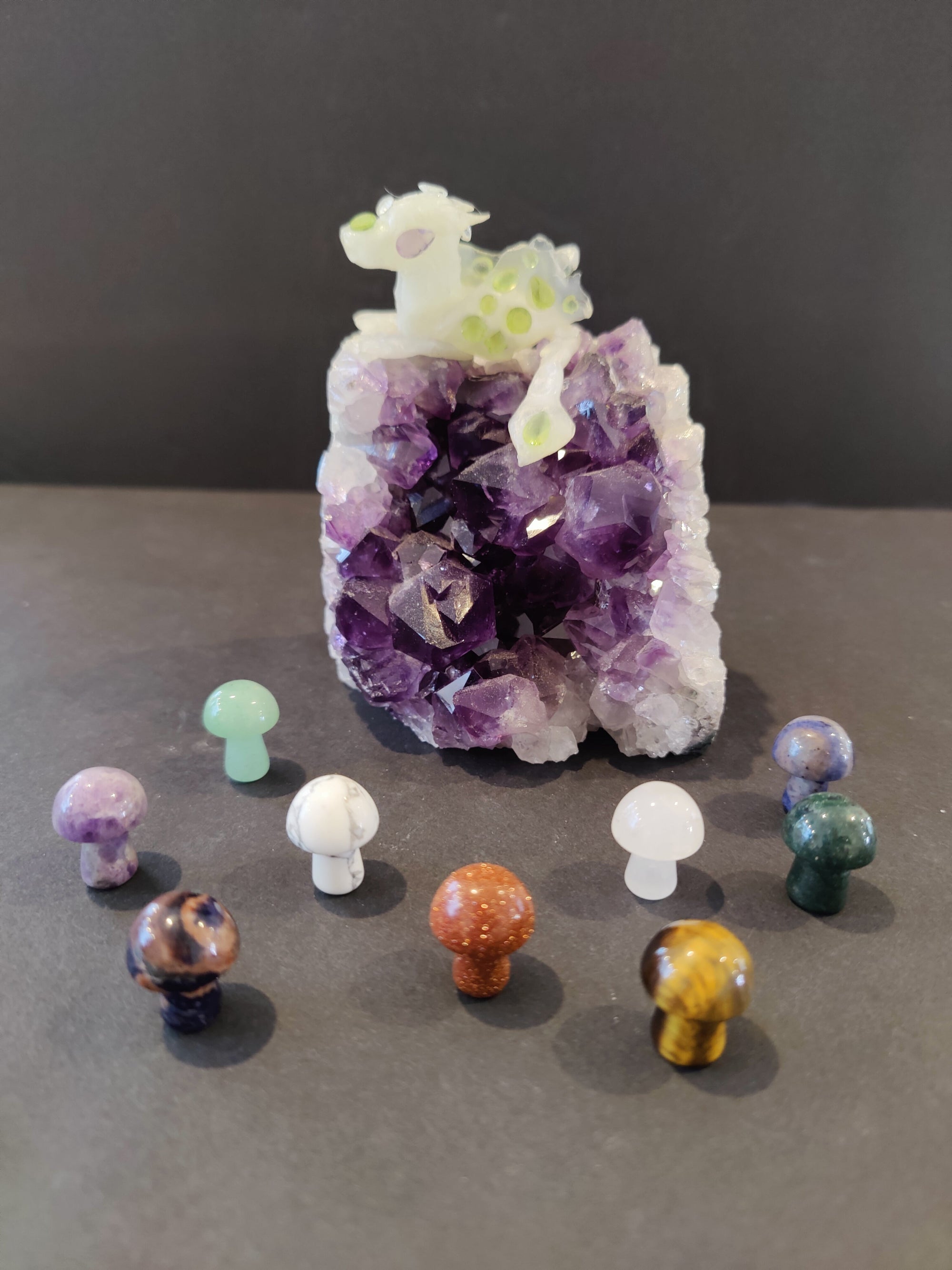 Pocket sized mushroom stone sculpture on a plain surface