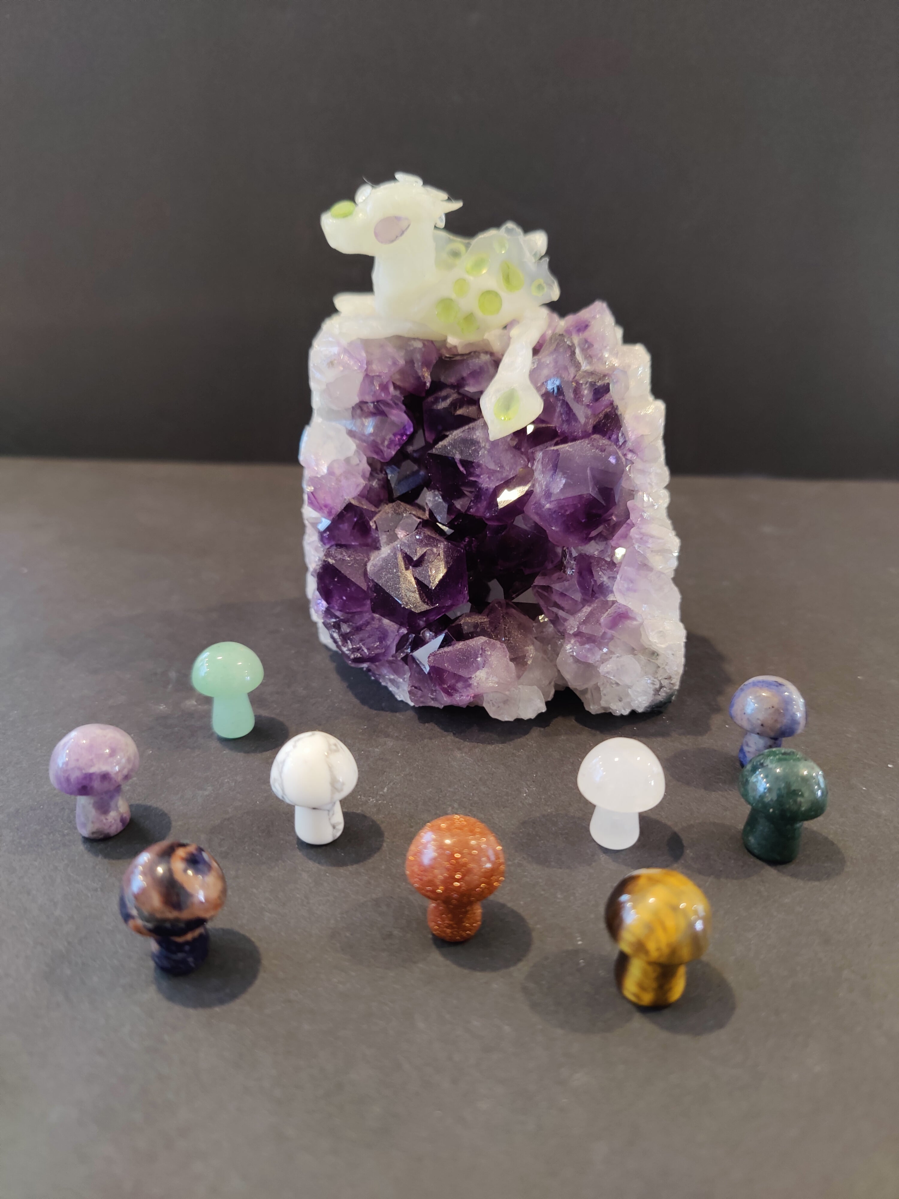 Pocket sized mushroom stone sculpture on a plain surface