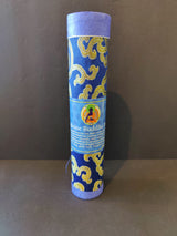 Tall cylindrical container wrapped in blue fabric with gold swirling patterns and a label featuring a seated Buddha illustration in green and orange hues.