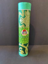 Cylindrical green package decorated with intricate gold floral patterns and a label featuring a colorful deity illustration for Green Tara Incense.