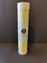 Cylindrical container wrapped in pale gold fabric with intricate patterns, featuring a label with a colorful deity illustration and text about White Tara incense.
