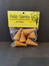 Clear plastic bag containing several brown Palo Santo incense cones with a yellow label displaying the product name and benefits against a black background.