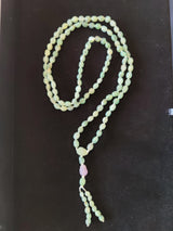 Gobi Desert Green Moss Agate with Amethyst Bead Mala Necklace laid flat showing green beads with a single purple bead