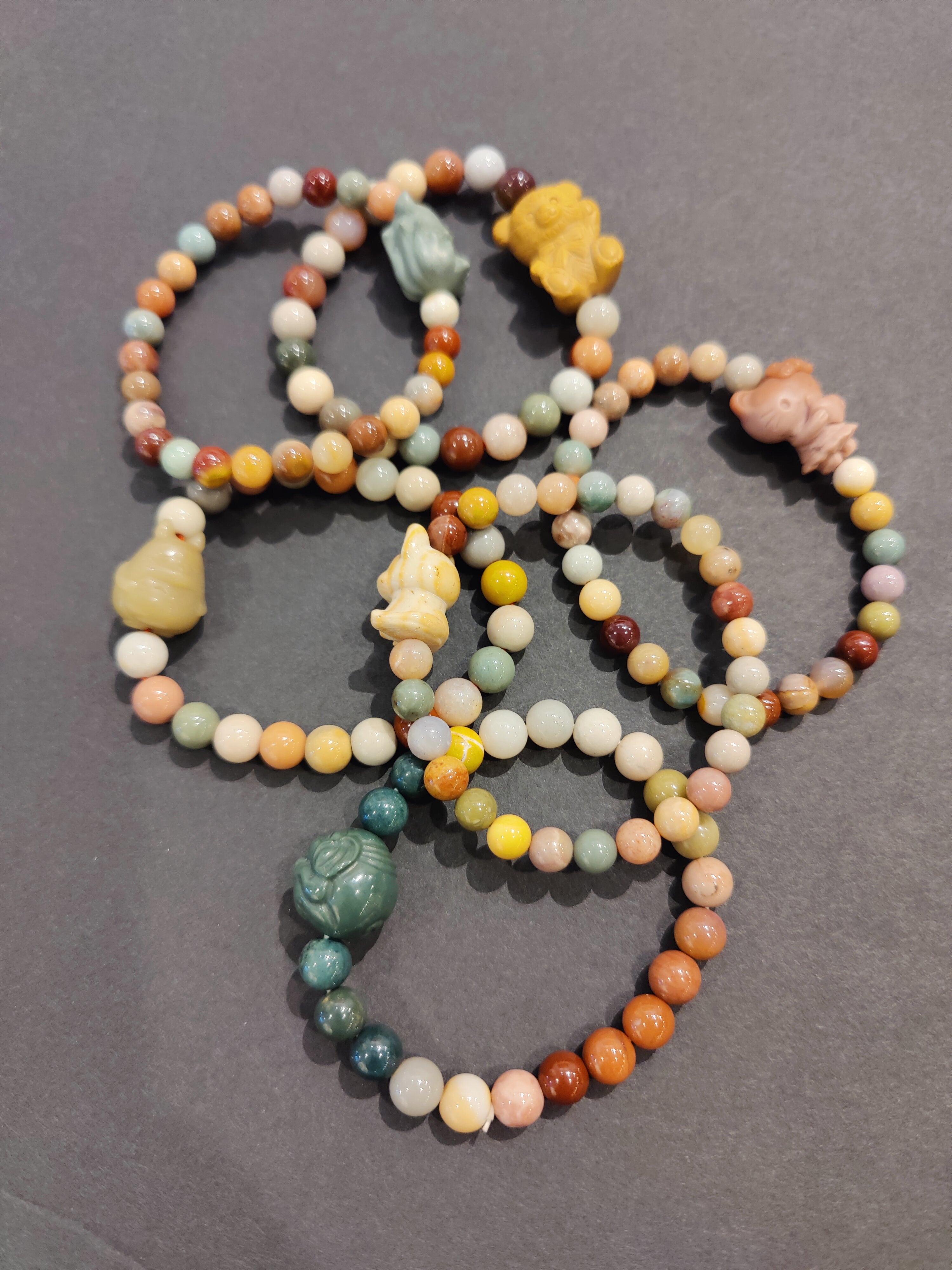 Jasper Multi-Color Bead Bracelet with a small light-colored elephant charm on a white background