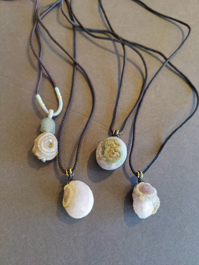 Gobi Desert Eye Agate pendant on a black cord necklace, showcasing natural stone patterns