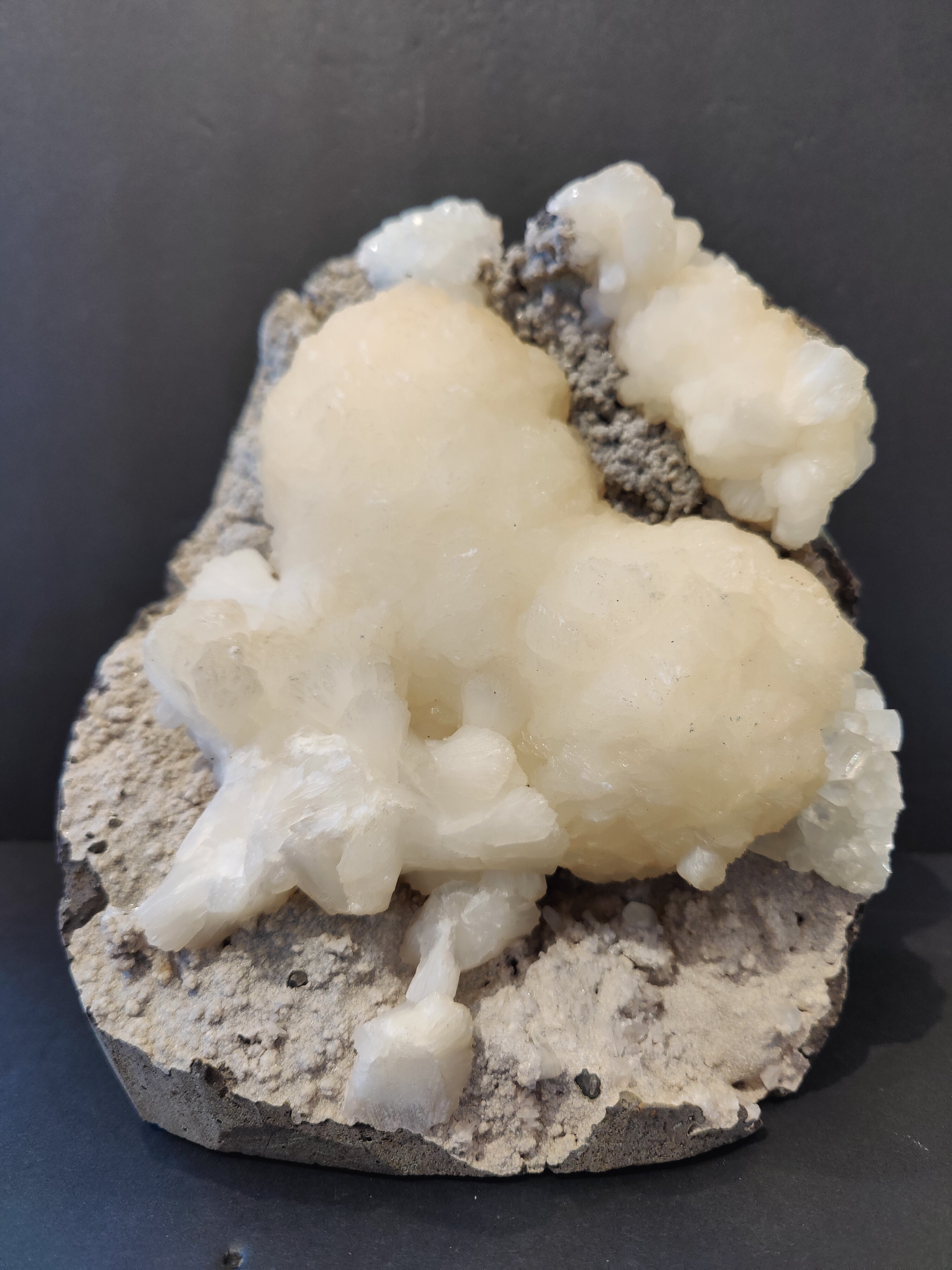 Stilbite heart shaped mineral with clear apophyllite crystals on matrix