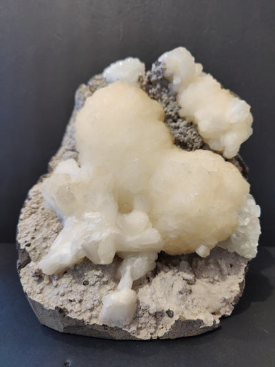 Stilbite heart shaped mineral with clear apophyllite crystals on matrix