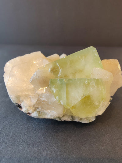 Green Apophyllite cubes with peach Stilbite crystals on matrix from Nashik, India