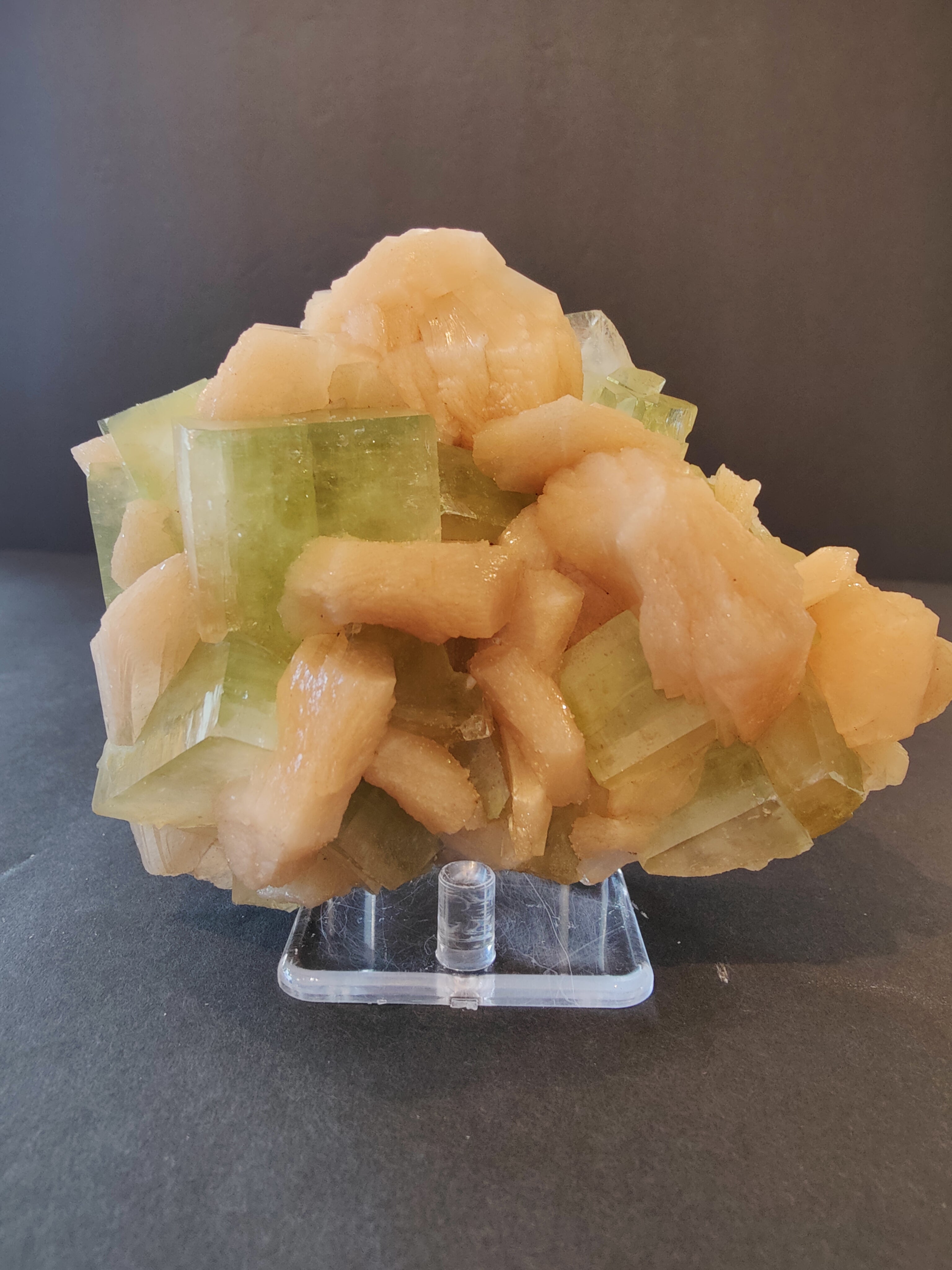 Green apophyllite cube crystals combined with peach stilbite clusters on matrix rock, photographed from multiple angles.