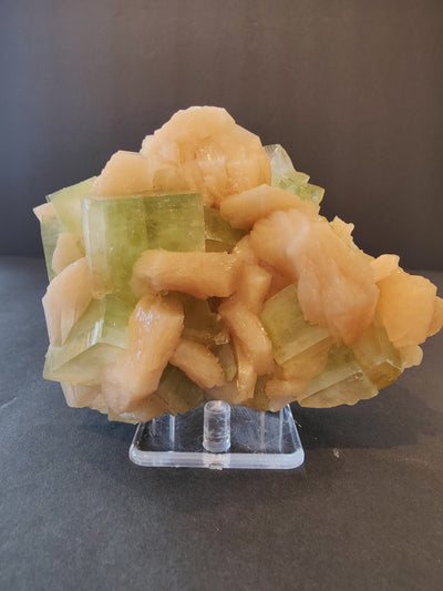 Green apophyllite cube crystals combined with peach stilbite clusters on matrix rock, photographed from multiple angles.