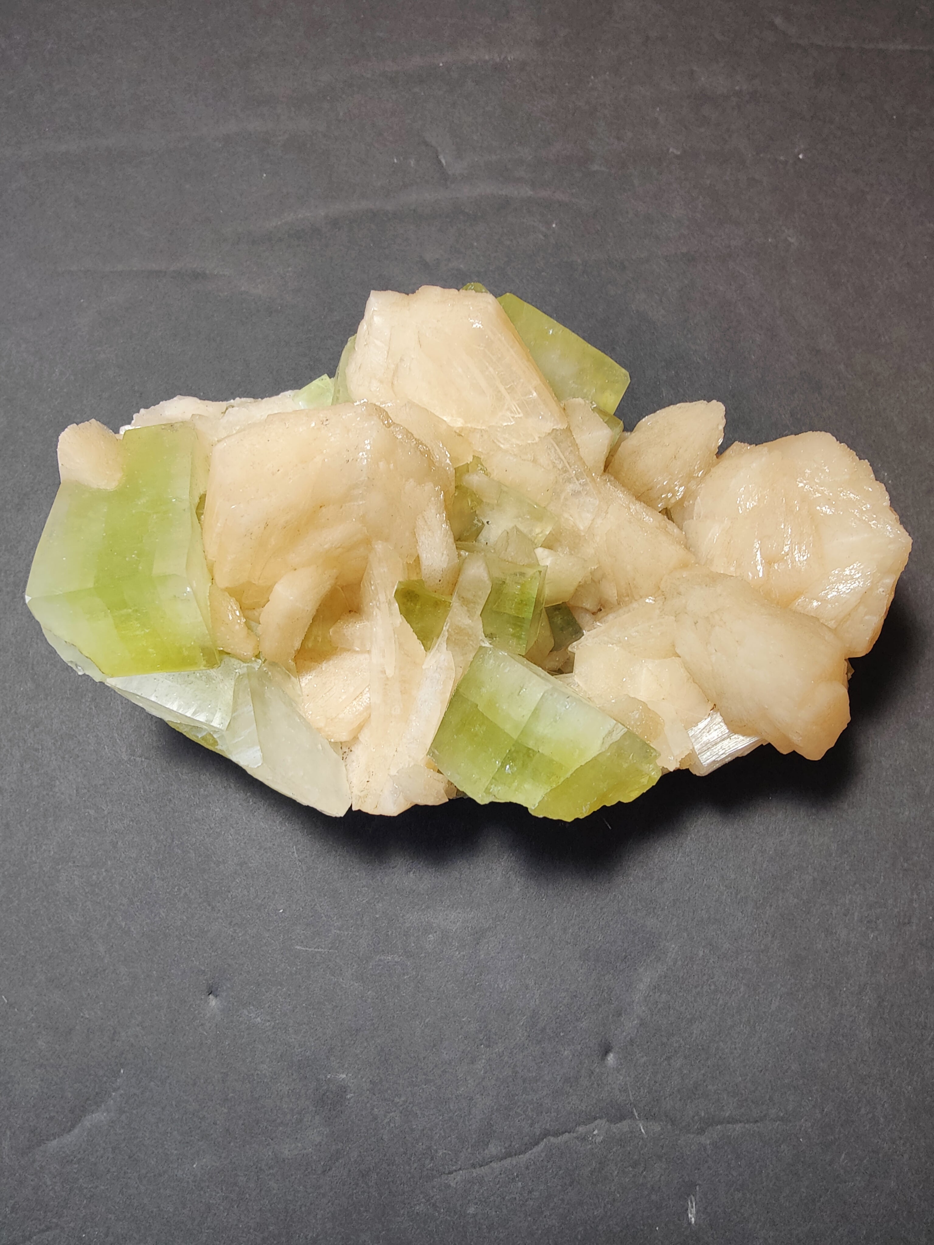 Green apophyllite cubes with peach stilbite specimen on matrix photographed from multiple angles.