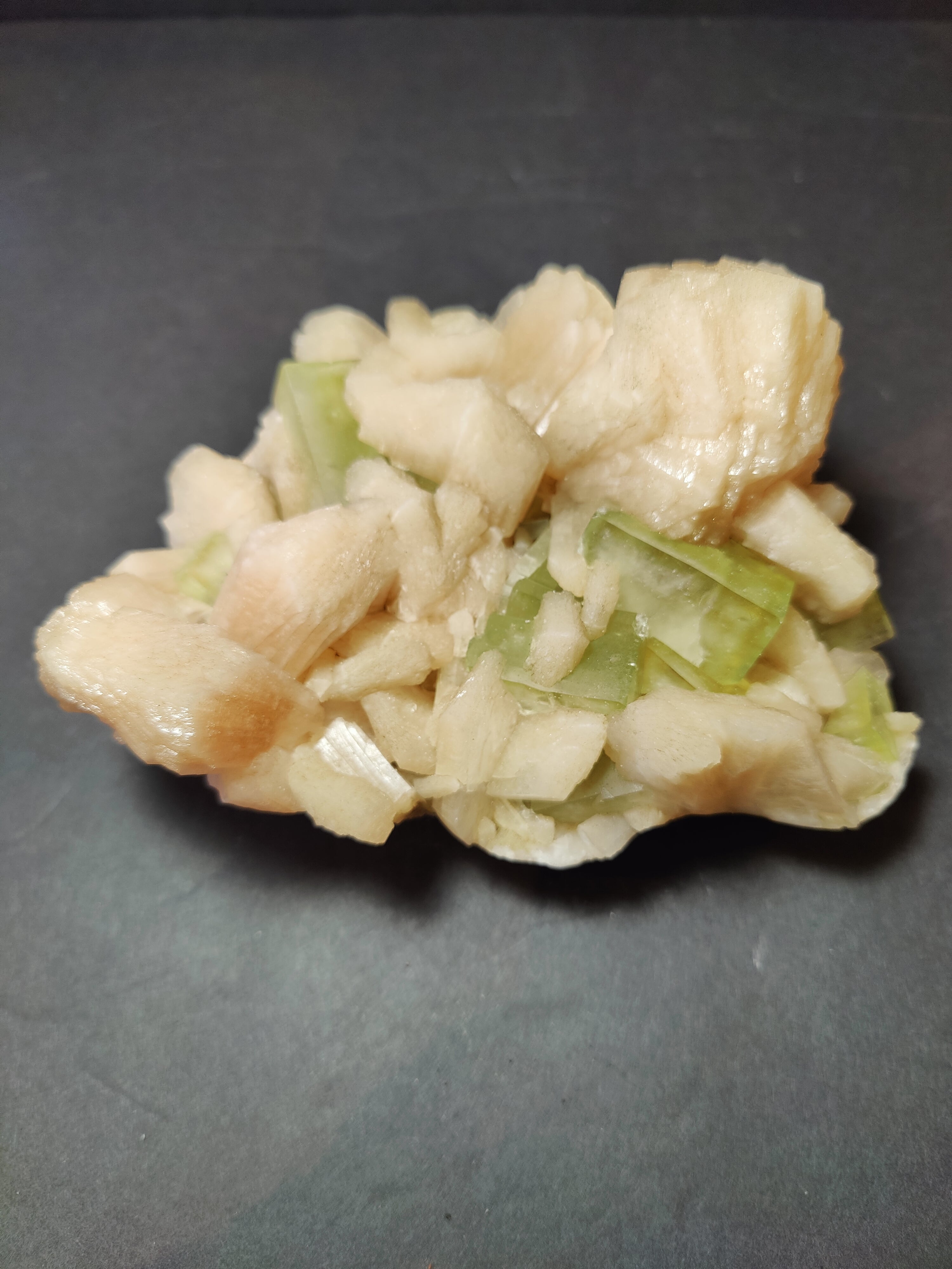 Green apophyllite cubes with peach stilbite on matrix mineral specimen