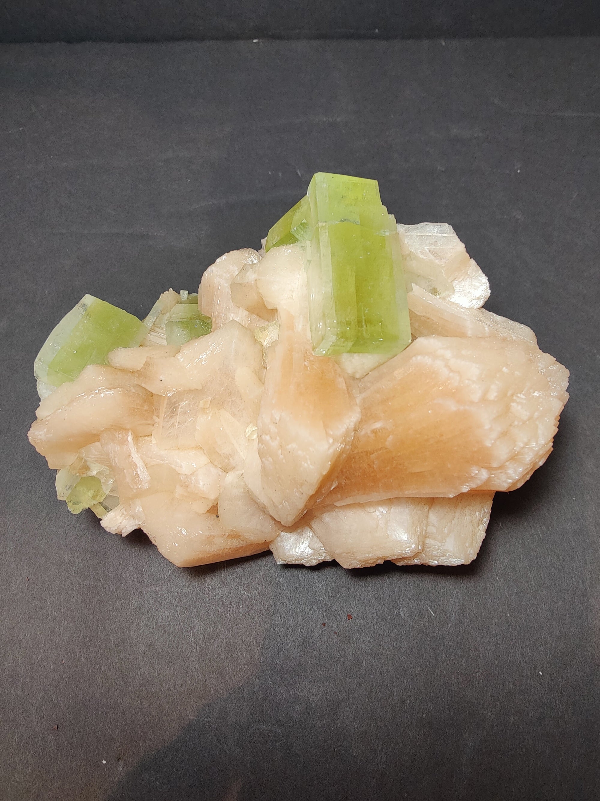 Green apophyllite cubes with peach stilbite on matrix mineral specimen
