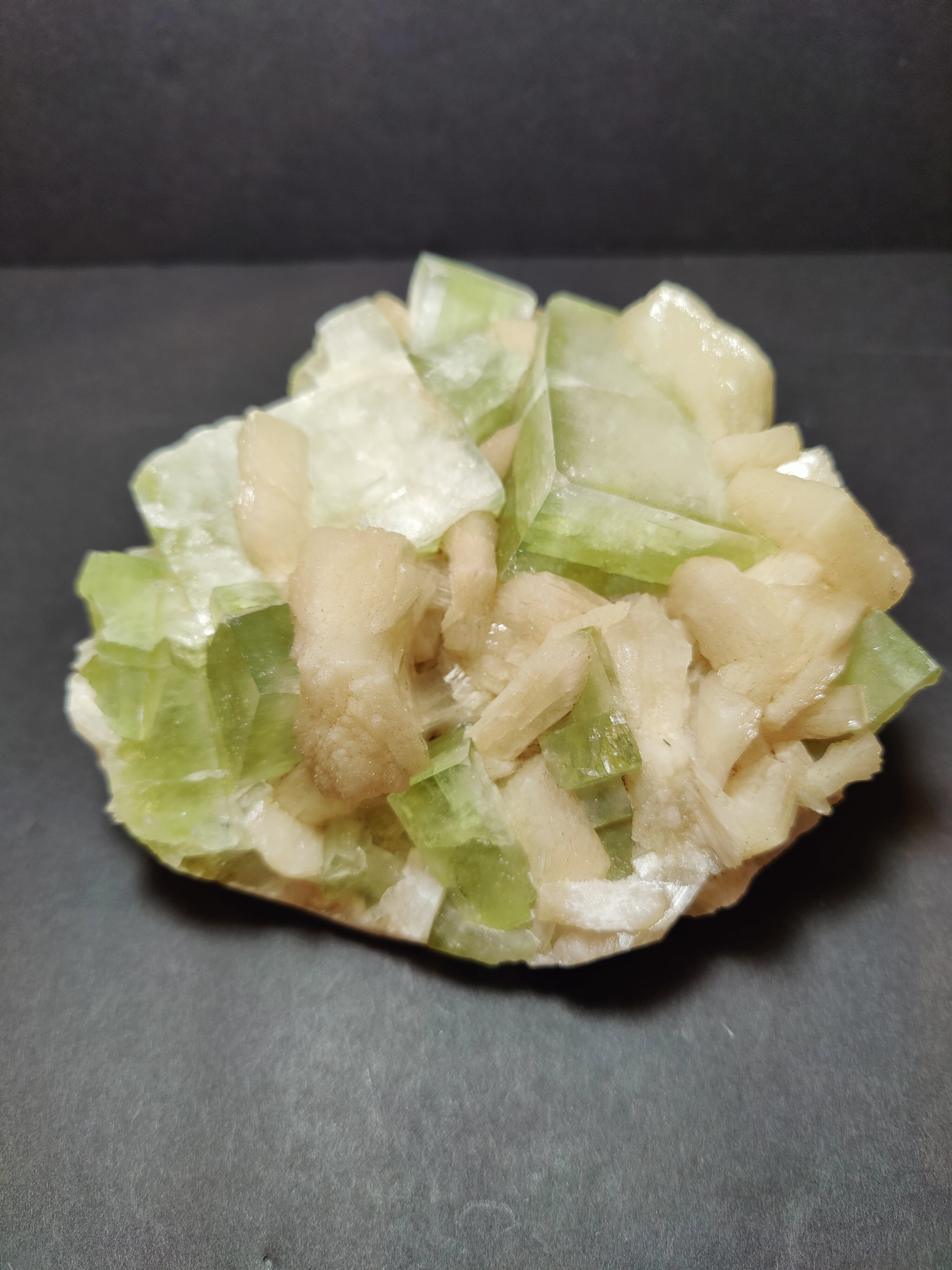 Green Apophyllite cubes with peach Stilbite specimen displaying geometric crystals on matrix