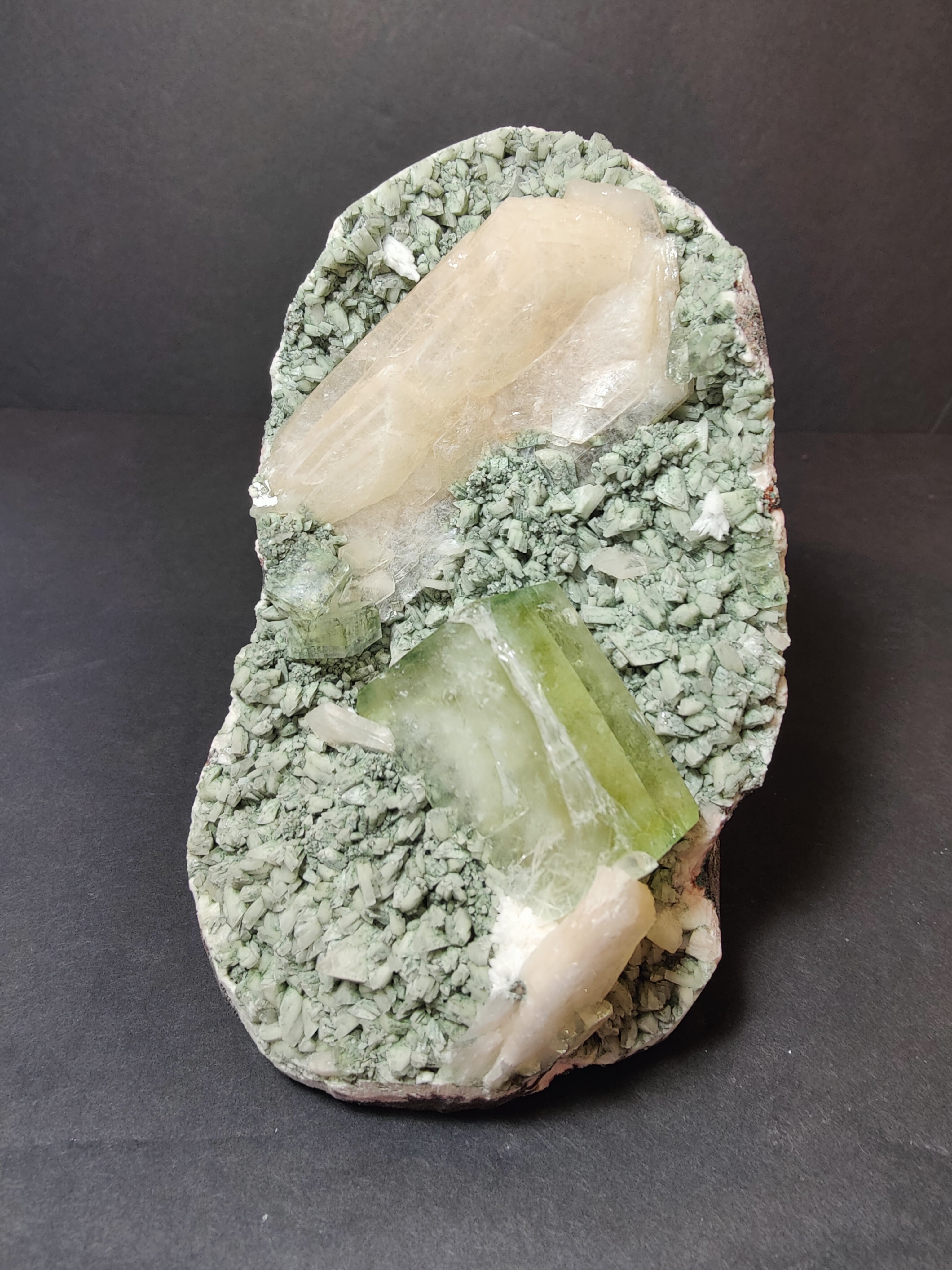 Green Apophyllite cubes with peach Stilbite crystals on green Heulandite mineral matrix