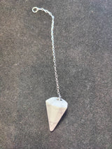 White marble-patterned stone pendulum with six-faceted pointed shape, attached to a silver chain with a lobster clasp, on a dark textured background.