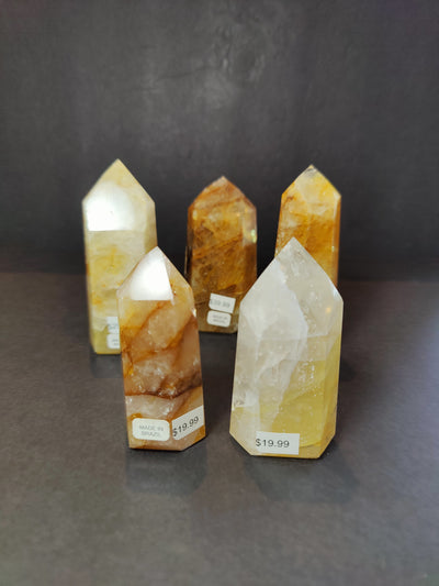 Polished Golden Healer Hematoid Quartz Obelisk Tower Sculpture upright on white surface