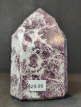Polished lepidolite obelisk tower sculpture with purple and white marbled pattern, standing upright with a $29.99 price sticker on the front