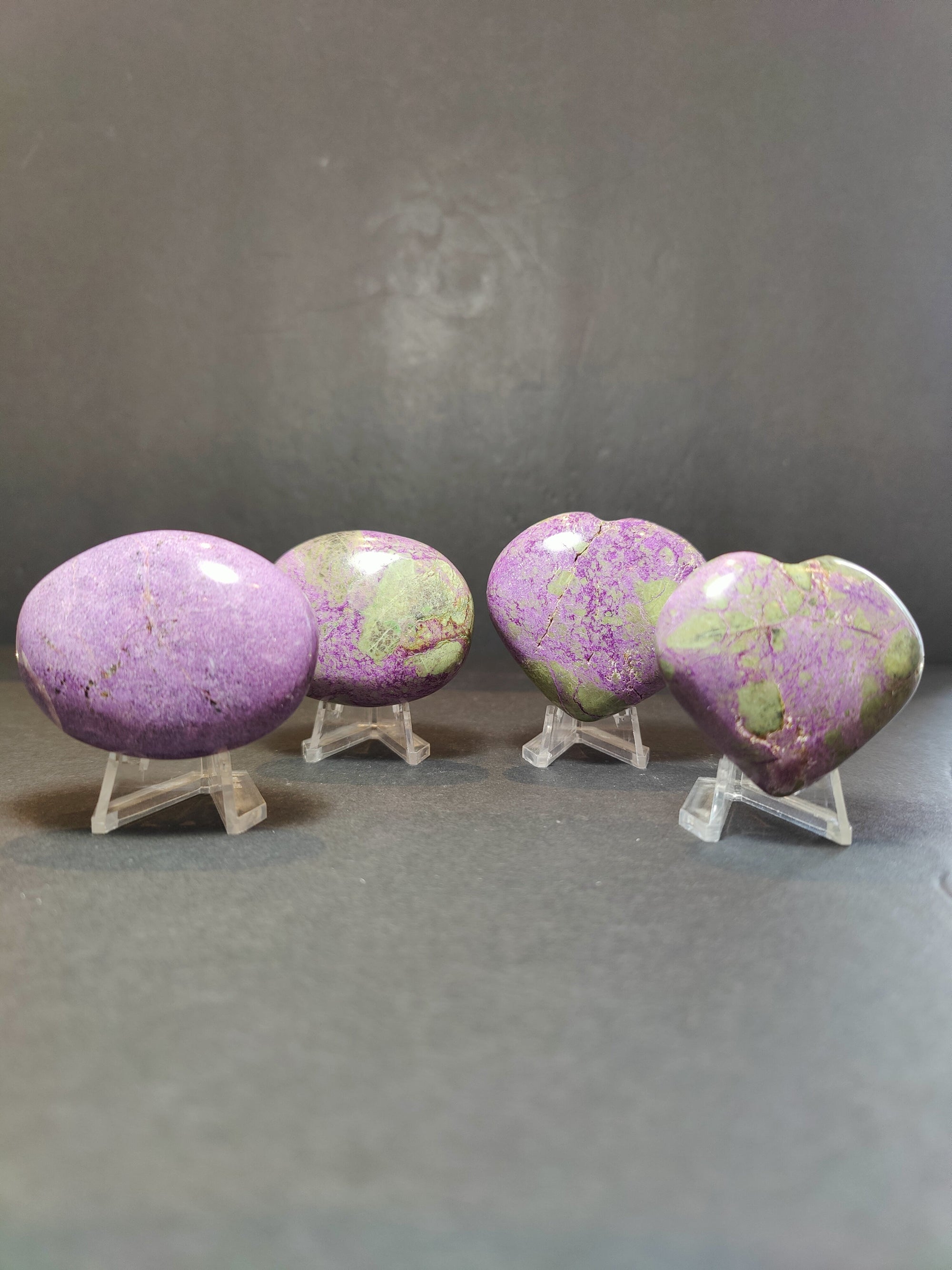 Polished Atlantisite Heart and Palmstone sculptures in purple and green shades