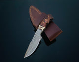 DAMASCUS STEEL FIXED BLADE KNIFE WITH WALNUT & STAG HORN HANDLE shown from side on wood background