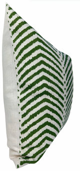 Rectangular pillow with a white linen back and front featuring a green zigzag chevron pattern on a white background, shown at a side angle.
