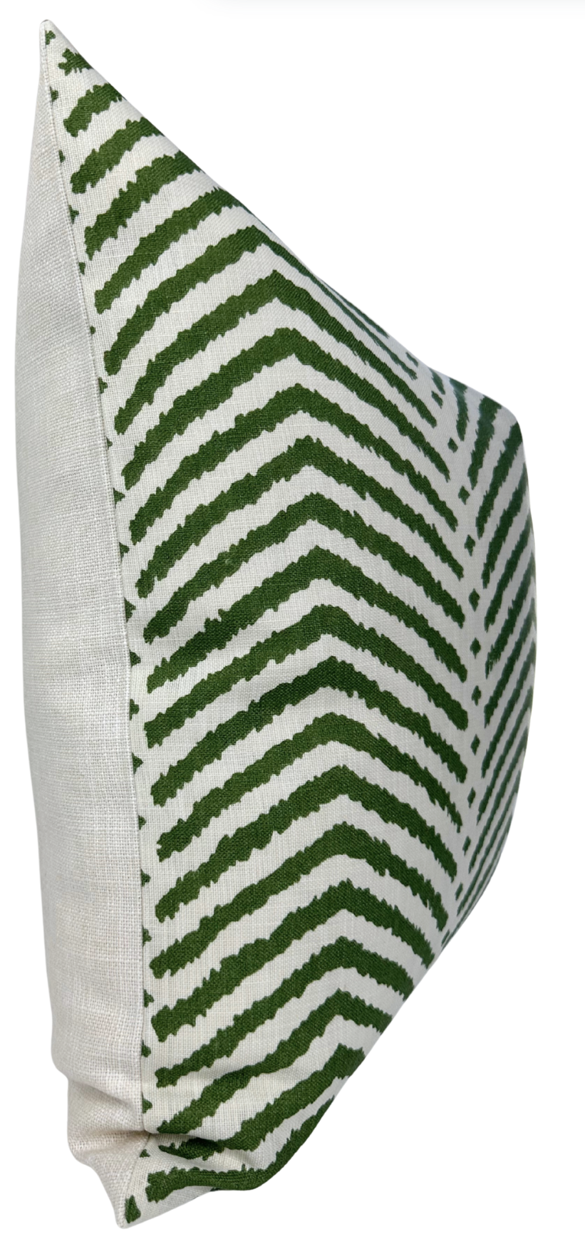 Rectangular pillow with a white linen back and front featuring a green zigzag chevron pattern on a white background, shown at a side angle.