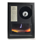 Glass display box containing a fragment of genuine Nantan meteorite with label and color image